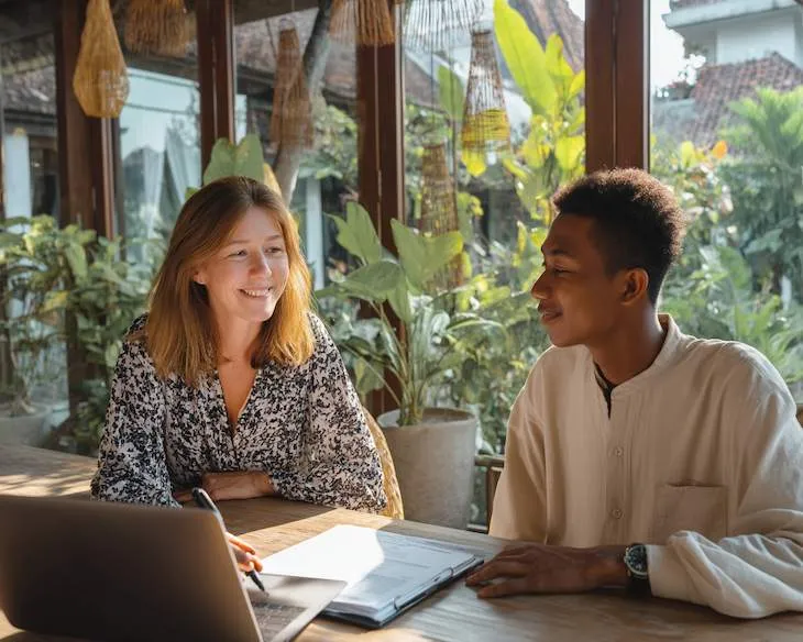 PT PMA tax consultant in Bali helping a French entrepreneur review VAT penalties and legal documents for compliance.
