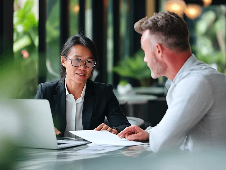  Lawyers and accountants in Bali discussing PT PMA tax compliance, reviewing legal documents and VAT reports