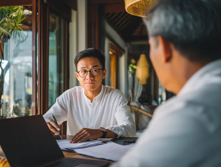 PT PMA resort manager in Bali reviewing PPH Article 21 tax incentive documents to reduce payroll deductions for tourism employees