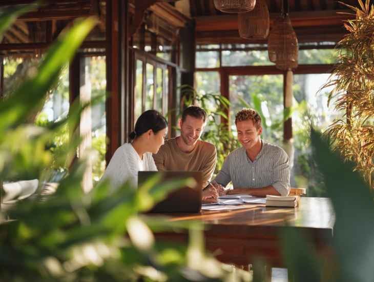 Multinational finance team in Bali analyzing PT PMA and global tax documents, optimizing international compliance and VAT reporting