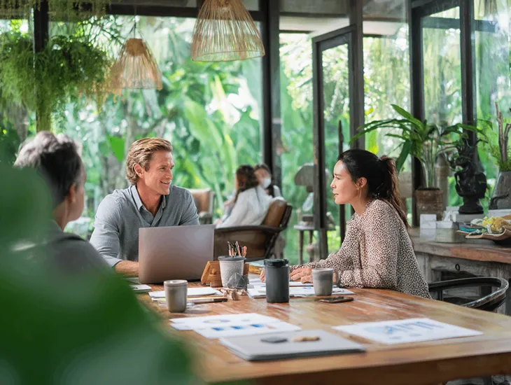 Foreign PT PMA director in Bali reviewing financial reports and e-Faktur data with accountant before submitting annual corporate tax return via DJP Online