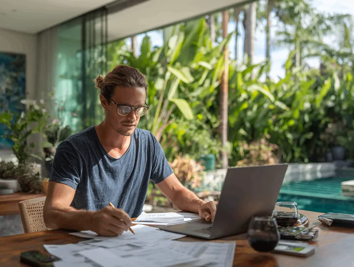 Foreign PT PMA investors in Bali reviewing digital tax reports on Coretax DJP Online amid Indonesia’s 2025 tax revenue reform