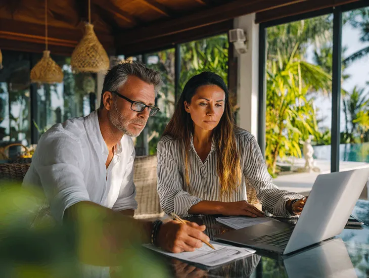 Foreign PT PMA owner in Bali reviewing suspicious tax emails and verifying invoices through official pajak.go.id portal to avoid scams